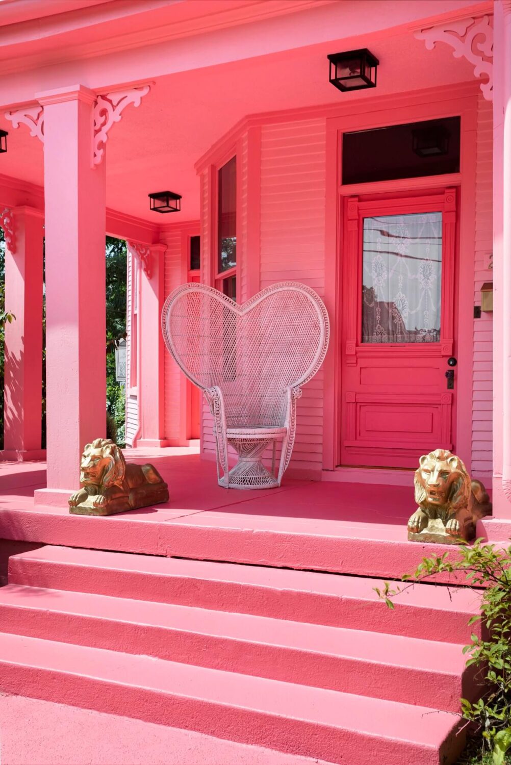 Barbiecore Interiors: The New Colorful & Fun Design Trend 8 veranda-pink-house-exterior-peacock-chair-barbiecore-nordroom
