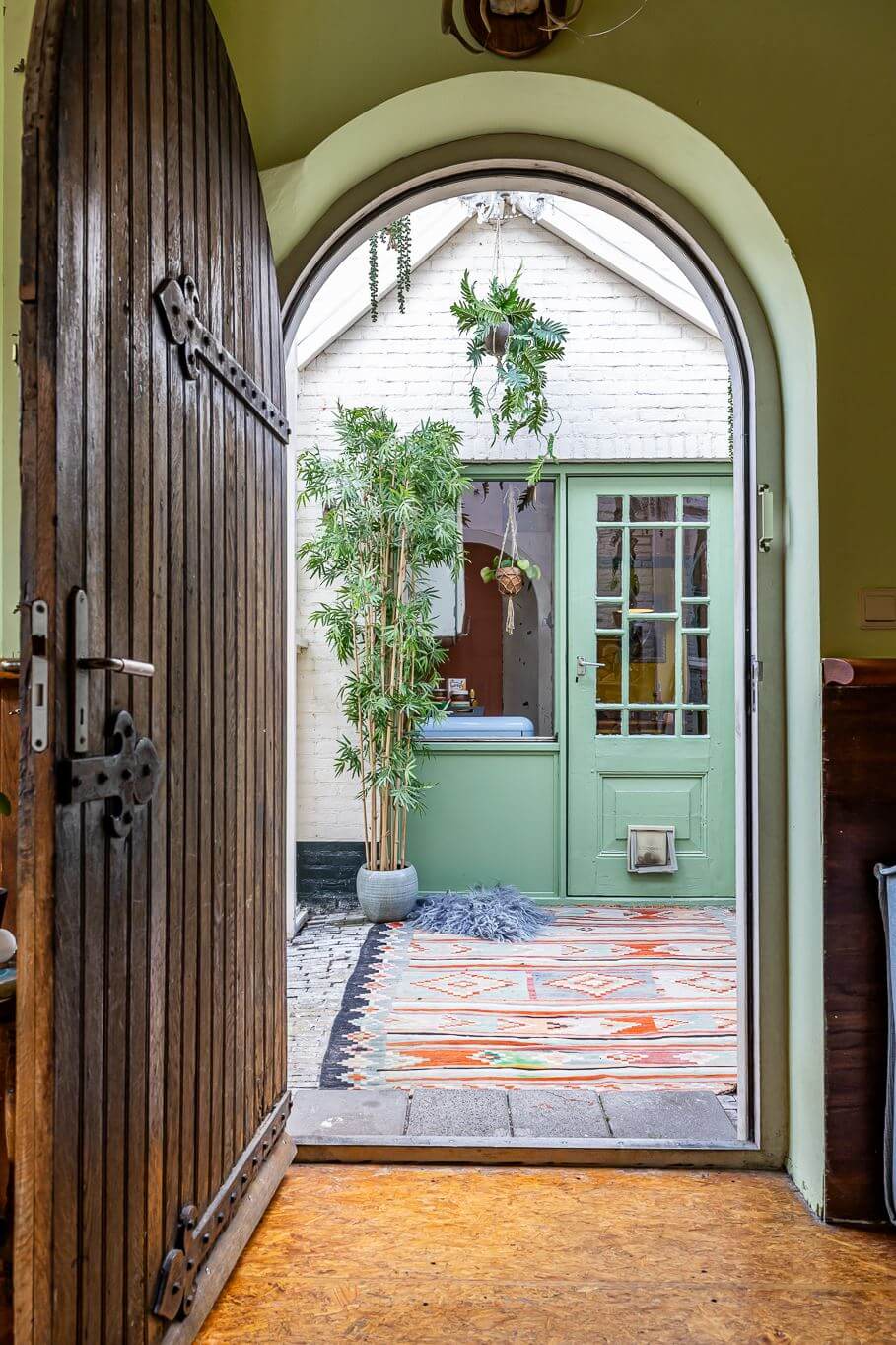 A Colorful Church Conversion in The Netherlands 10 arched-wooden-door-church-conversion-nordroom