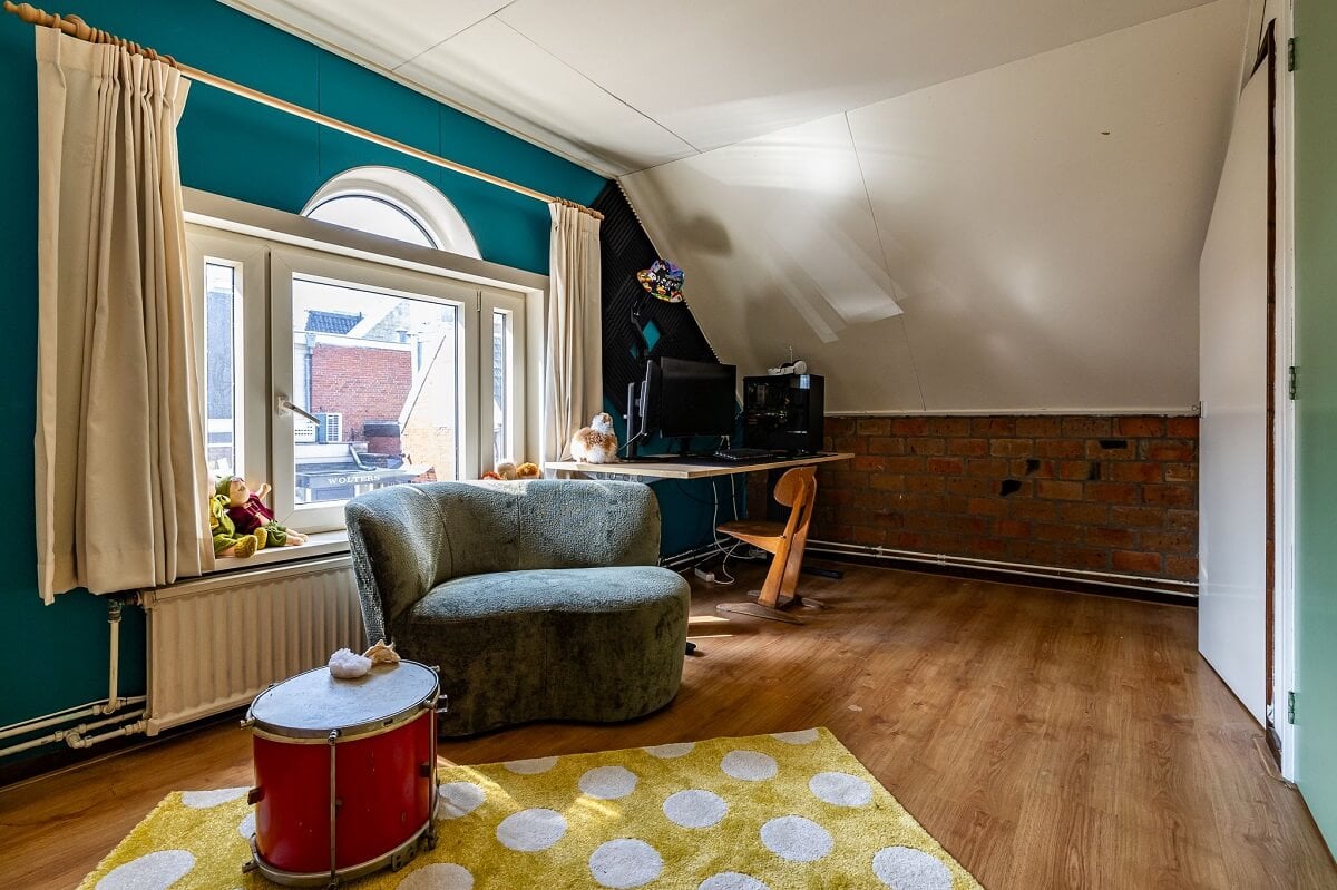 A Colorful Church Conversion in The Netherlands 29 attic-bedroom-blue-walls-exposed-brick-nordroom