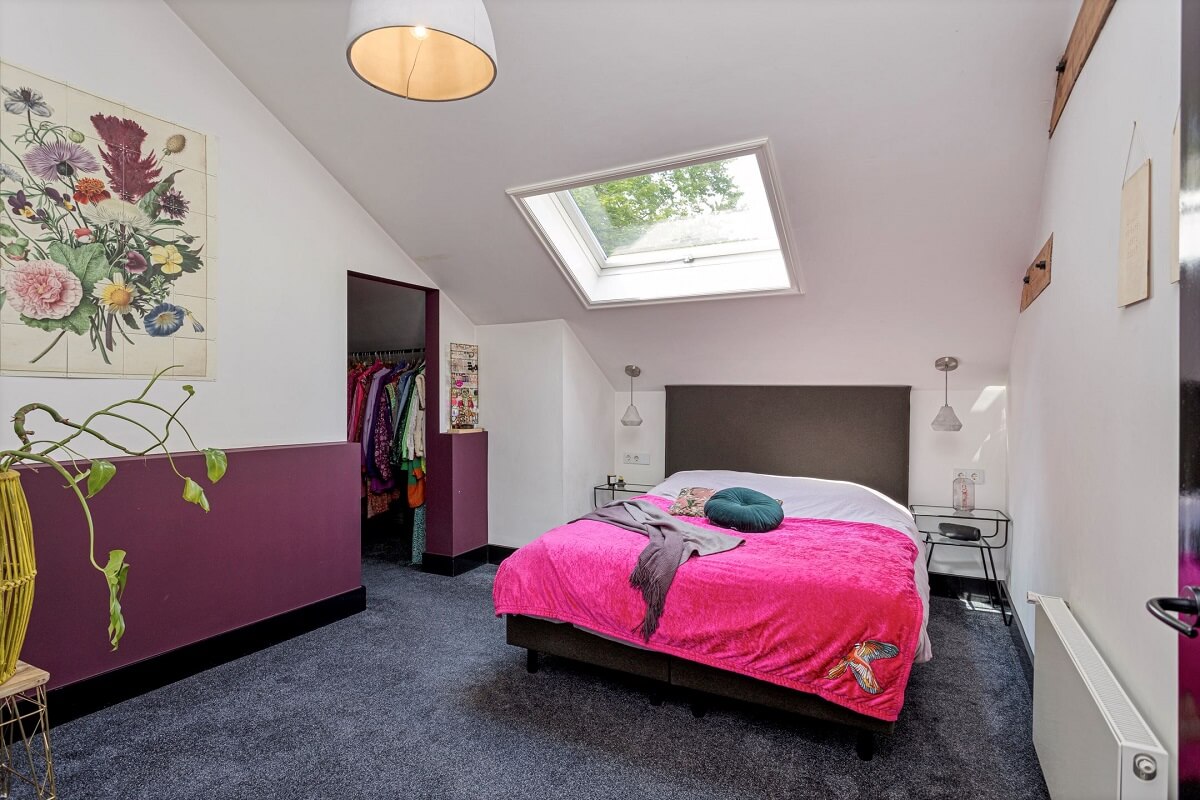 A Colorful School Conversion in The Netherlands 11 attic-bedroom-skylight-purple-half-painted-wall-walk-in-closet-nordroom