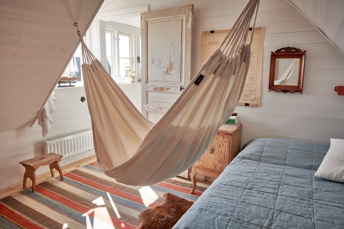Natural Light in a Charming Swedish Country House 23 attic-bedroom-slanted-ceiling-hammock-nordroom