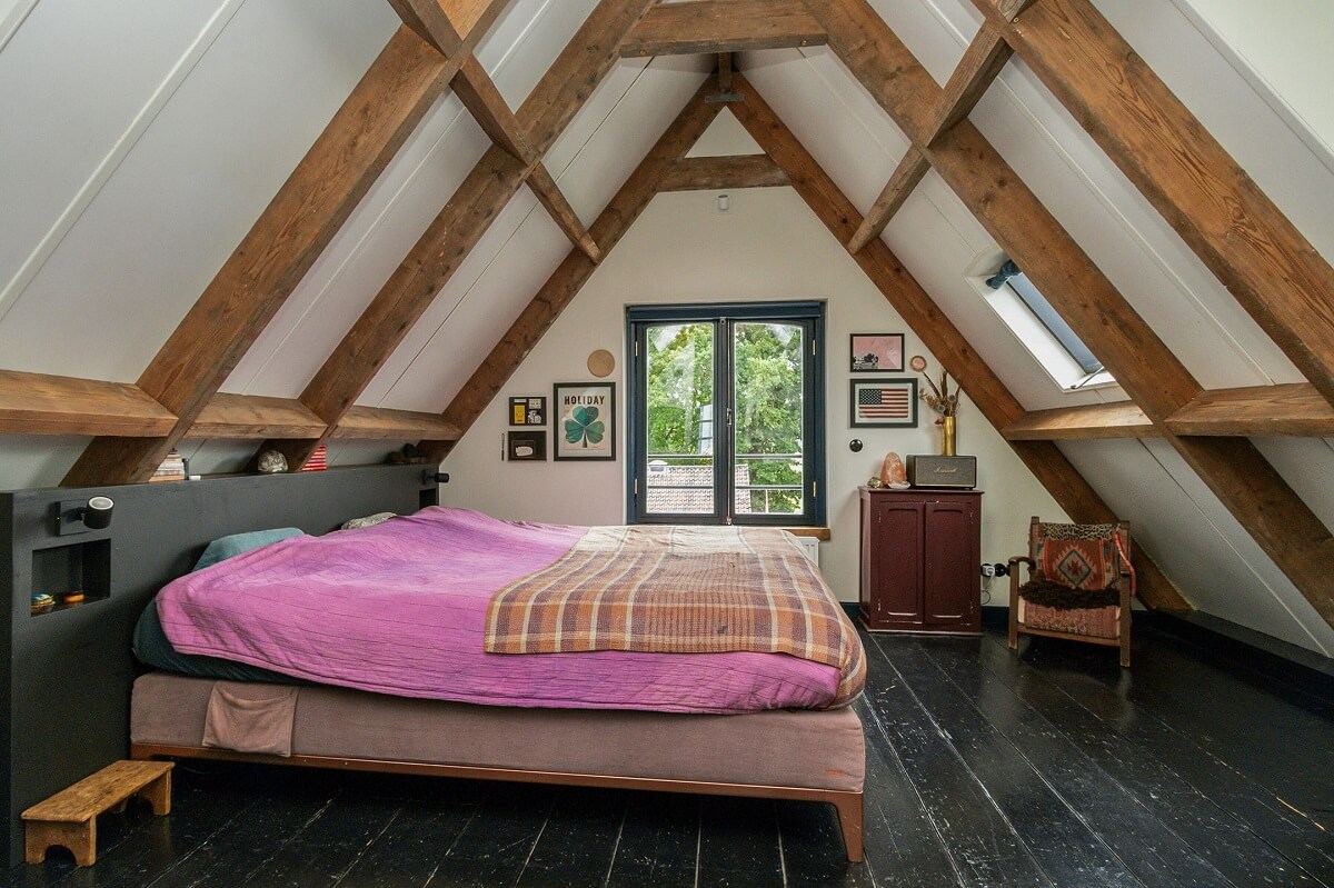 A Charming Colorful House in The Netherlands 12 attic-bedroom-slanted-ceiling-wooden-beams-nordroom