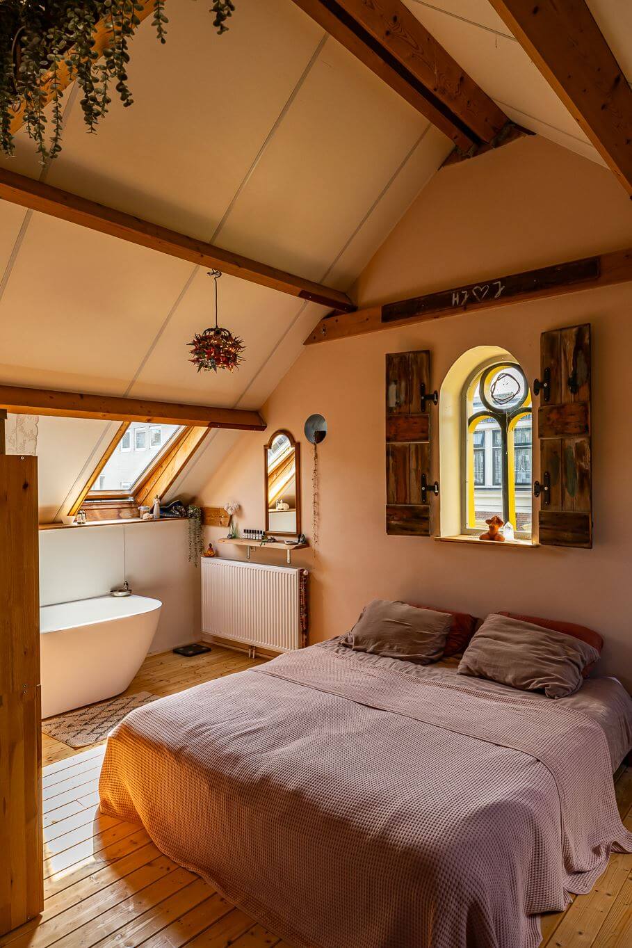 How To Decorate A Bedroom with A Slanted Ceiling 28 attic-bedroom-wooden-shutters-exposed-wooden-beams-freestanding-bath-nordroom