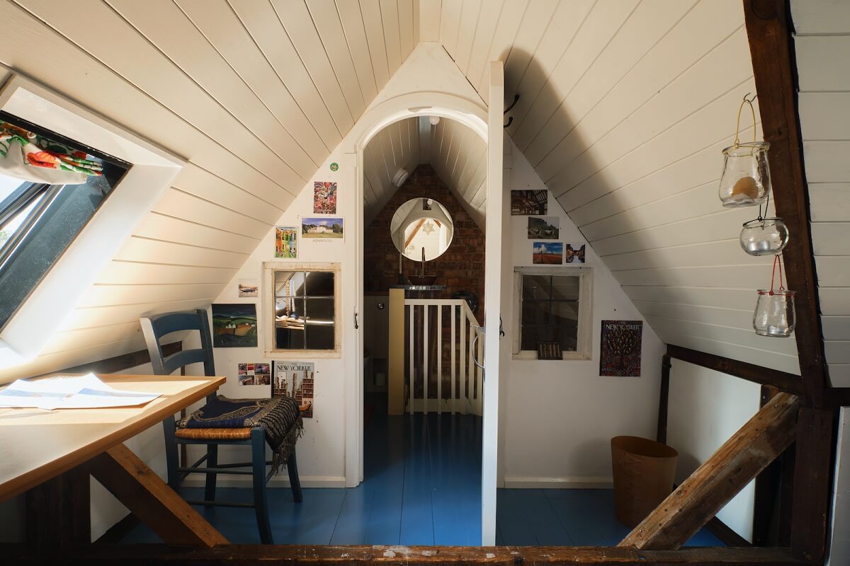 An English Cottage with Blue Color Accents 19 attic-room-slanted-ceiling-blue-floor-nordroom
