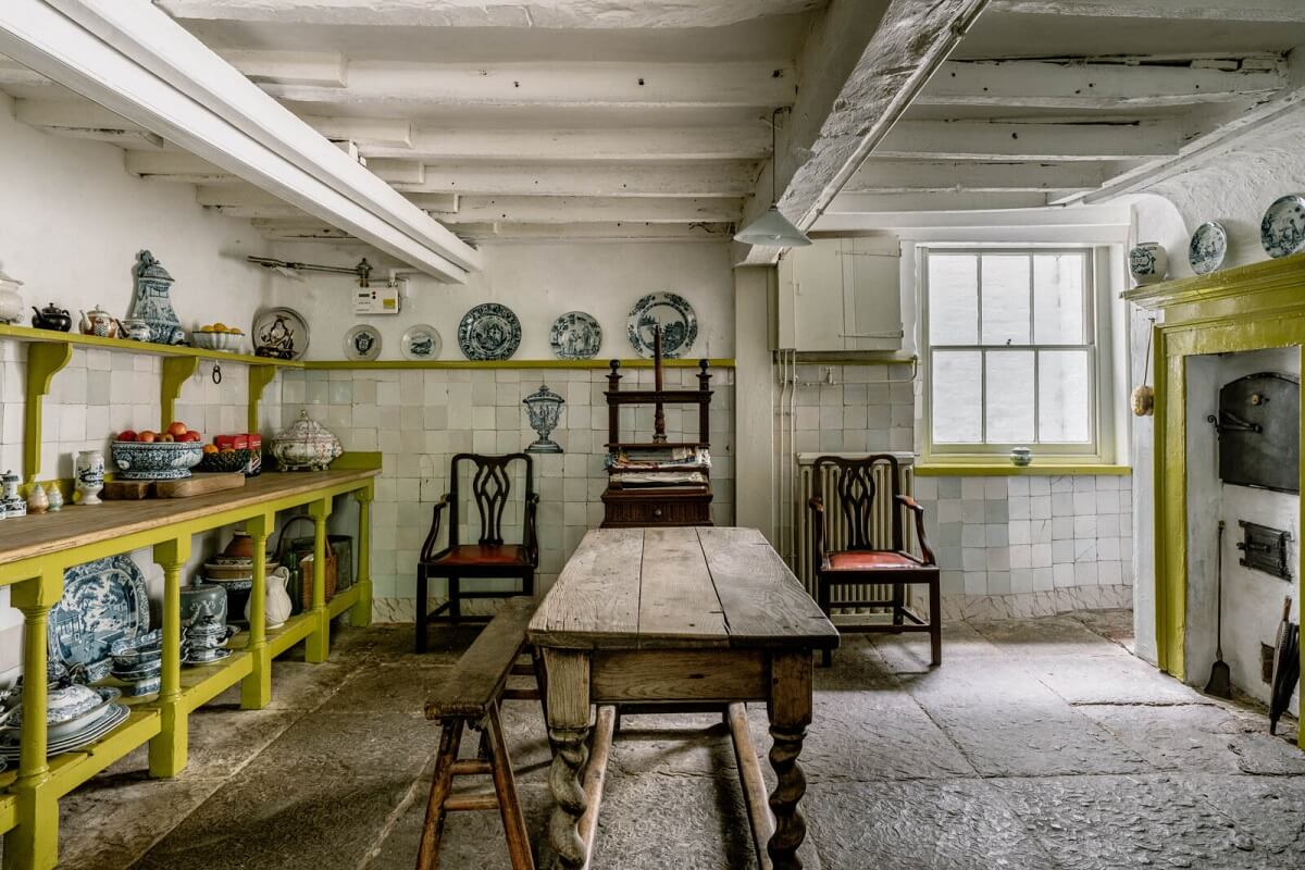 A Unique Historic House Near the English Coast 12 basement-kitchen-yellow-benches-rustic-wooden-table-nordroom