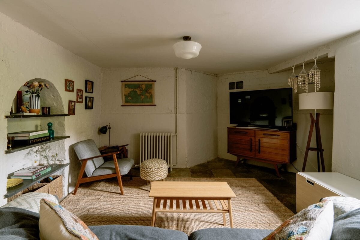 A Warm Living Room in a Historic English Home 12 basement-television-room-arched-shelving-nordroom