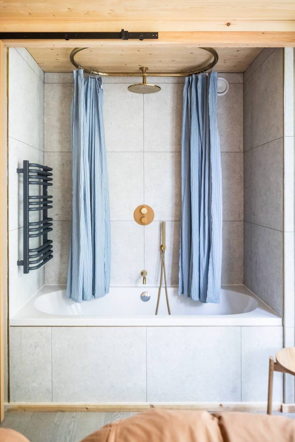 A Modern English Home with a Sculptural Facade 19 bath-with-shower-blue-round-curtains-nordroom