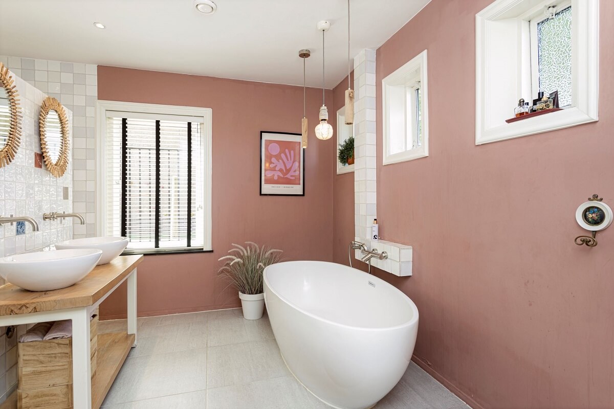 A Colorful School Conversion in The Netherlands 13 bathroom-pink-walls-modern-freestanding-bath-nordroom