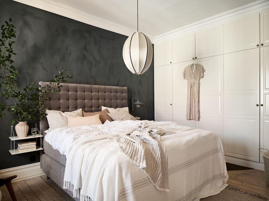 A Swedish Apartment with an Exposed Brick Wall 12 bedroom-dark-gray-wall-floating-nightstand-nordroom