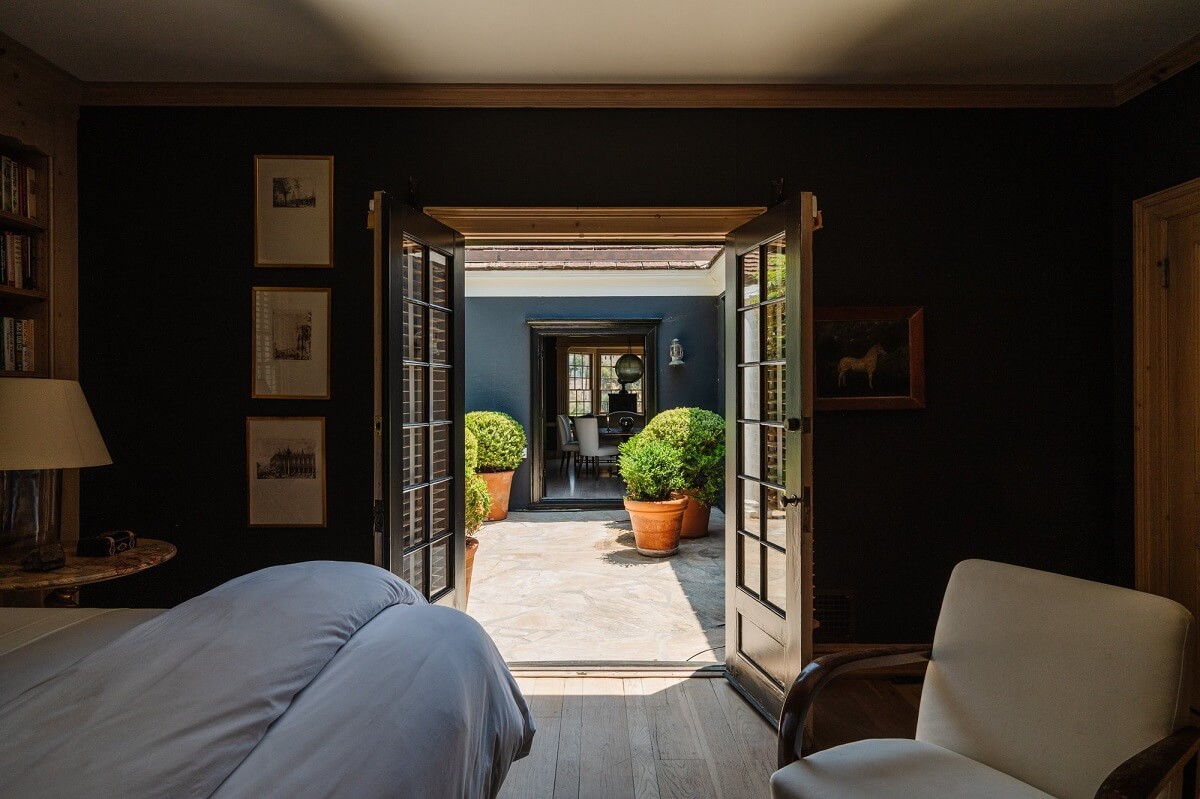 Black Accents in a Traditional Los Angeles Home 29 bedroom-double-doors-patio-nordroom