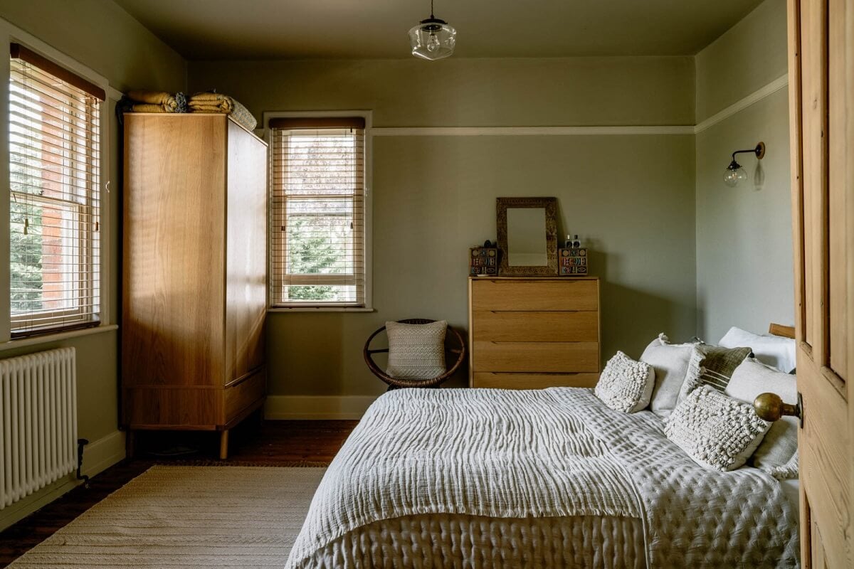 A Warm Living Room in a Historic English Home 18 bedroom-light-gray-walls-vintage-furniture-nordroom