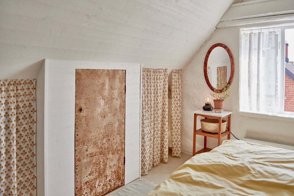 Natural Light in a Charming Swedish Country House 14 bedroom-slanted-ceiling-storage-under-eaves-curtain-nordroom