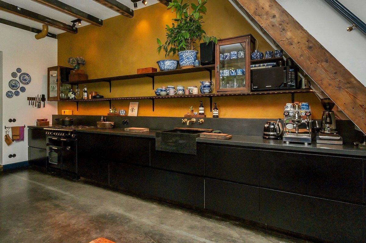 A Charming Colorful House in The Netherlands 2 black-kitchen-cabinets-mustard-yellow-walls-exposed-wooden-beams-nordroom