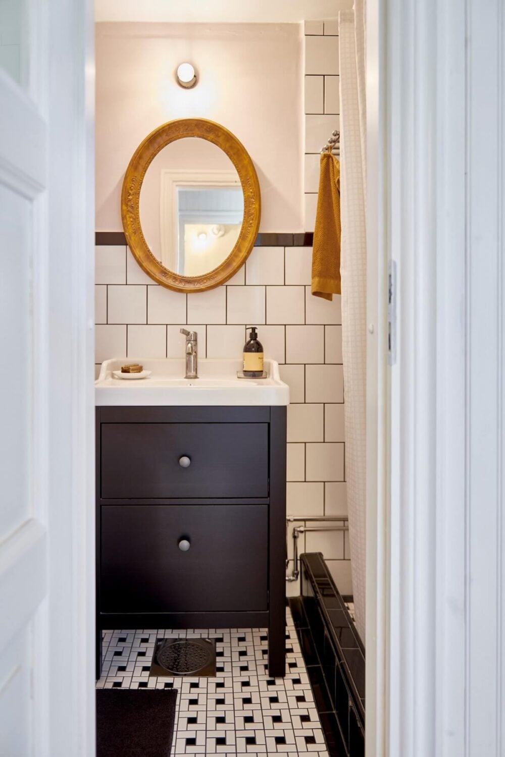 Natural Light in a Charming Swedish Country House 24 black-white-bathroom-oval-mirror-nordroom
