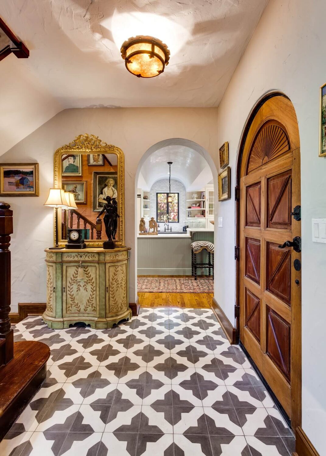A Beautiful Spanish Style Home in Florida 4 black-white-floor-tiles-rustic-wooden-front-door-nordroom