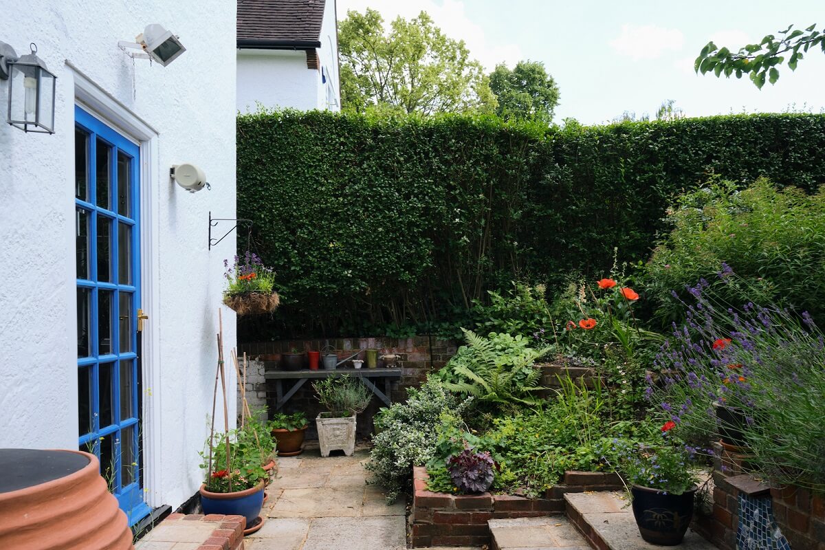 An English Cottage with Blue Color Accents 20 cottage-garden-white-exterior-blue-painted-door-nordroom
