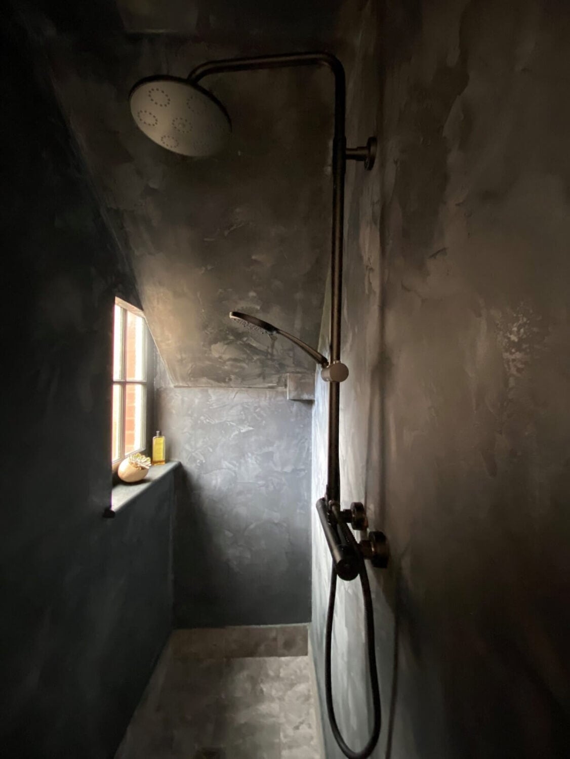 Loft Style Spaces in a Renovated Salvation Army Hall 19 dark-gray-shower-slanted-ceiling-window-nordroom