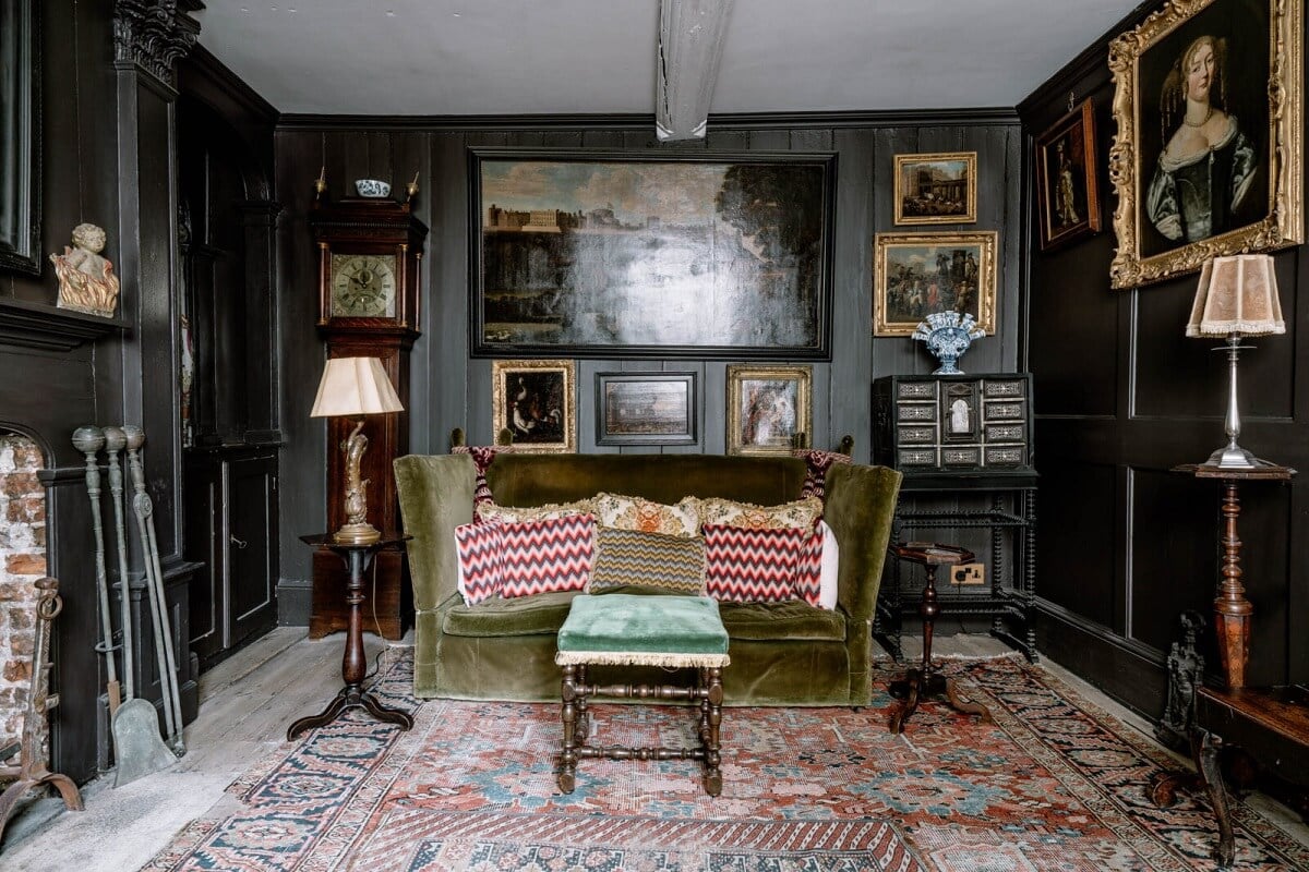 A Unique Historic House Near the English Coast 7 dark-gray-sitting-room-green-couch-antique-furniture-art-nordroom