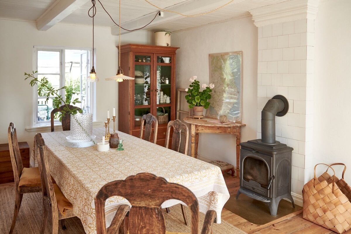 Natural Light in a Charming Swedish Country House 11 dining-room-antique-chairs-wood-burning-stove-nordroom