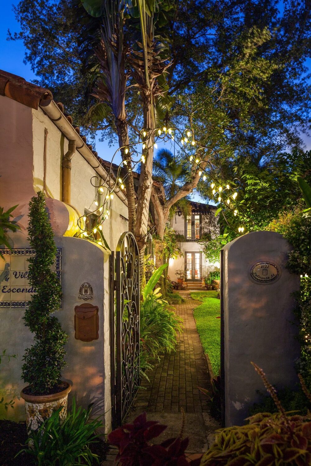 A Beautiful Spanish Style Home in Florida 38 entry-gate-walled-garden-at-night-nordroom