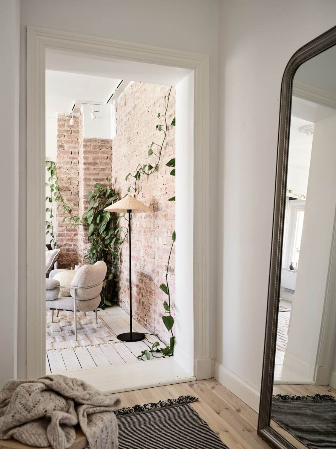 A Swedish Apartment with an Exposed Brick Wall 14 hallway-large-floor-mirror-wooden-floor-nordroom