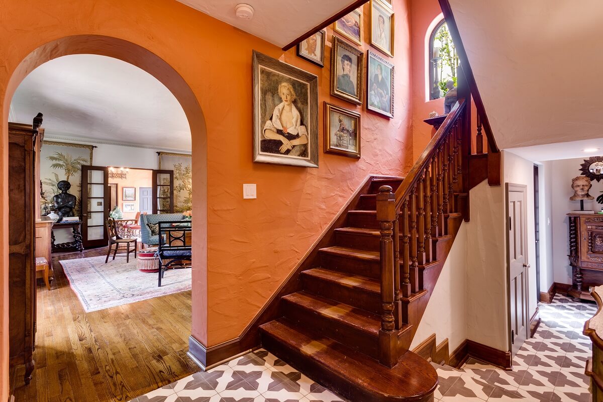 A Beautiful Spanish Style Home in Florida 3 hallway-orange-wall-floorvtiles-wooden-staircase-nordroom
