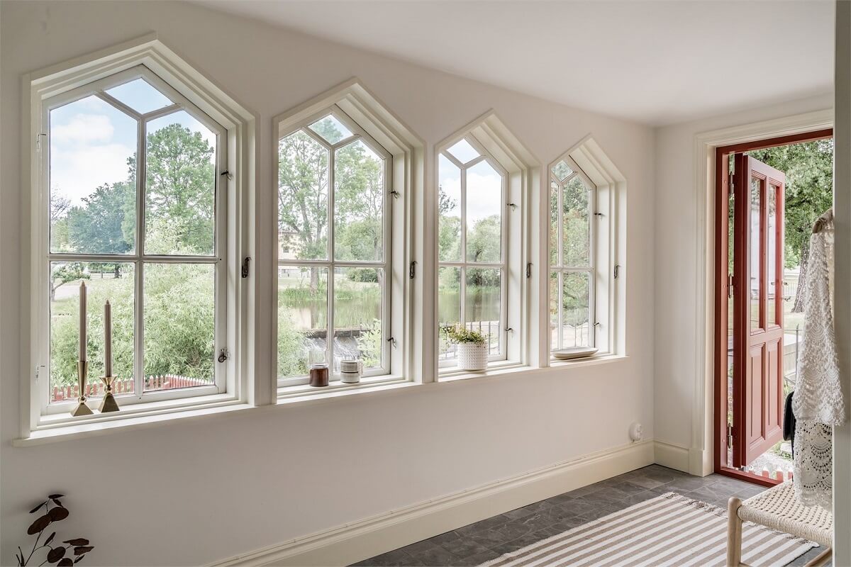 An Idyllic Small Swedish House with Wooden Beams 15 hallway-windows-overlooking-canal-nordroom
