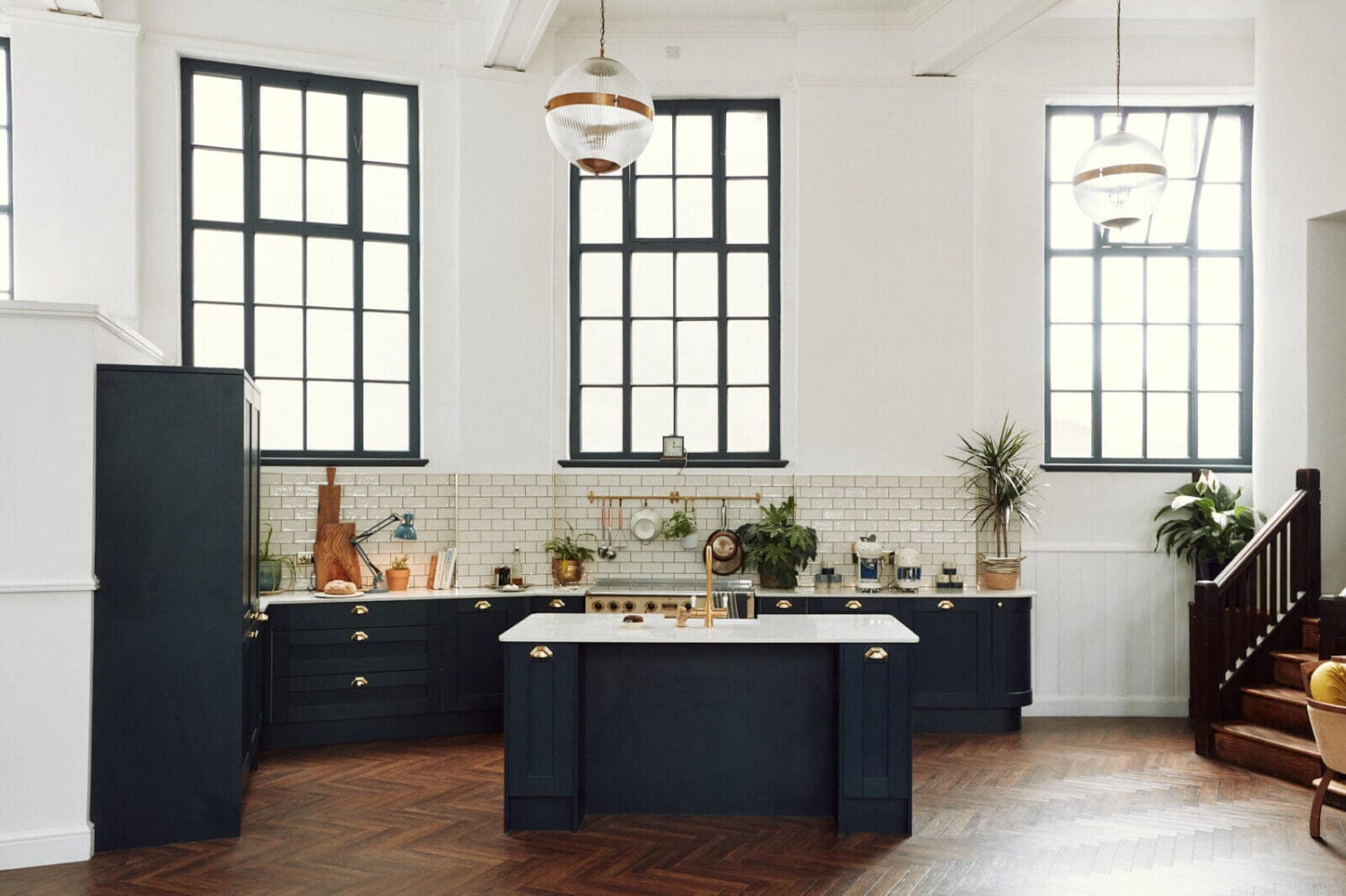 Loft Style Spaces in a Renovated Salvation Army Hall 6 kitchen-high-ceiling-large-windows-dark-blue-cabinets-island-nordroom
