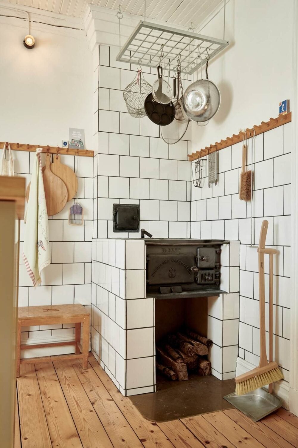 Natural Light in a Charming Swedish Country House 10 kitchen-original-stove-white-tiles-wooden-floor-nordroom
