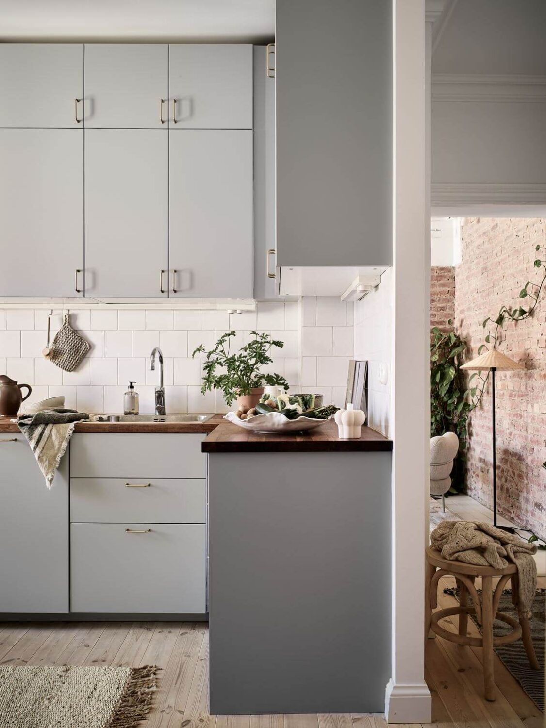 A Swedish Apartment with an Exposed Brick Wall 9 light-gray-kitchen-cabinets-nordroom
