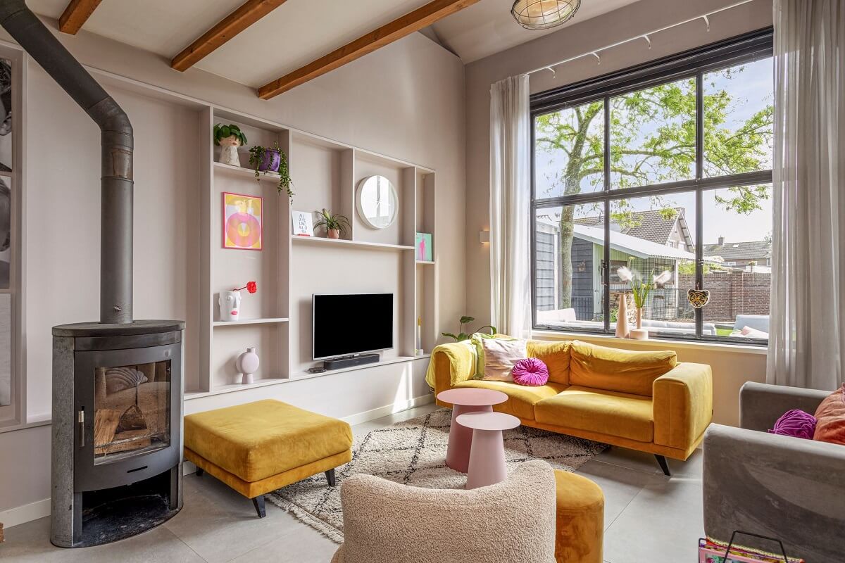 A Colorful School Conversion in The Netherlands 3 light-living-room-wood-burner-wooden-beams-nordroom