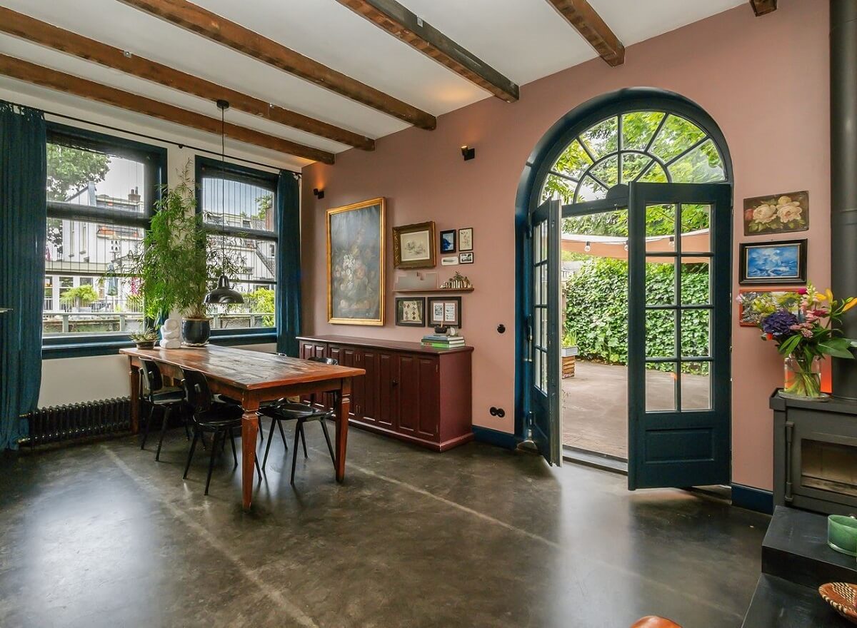 A Charming Colorful House in The Netherlands 4 living-room-dining-table-arched-window-doors-exposed-beams-pink-wall-nordroom