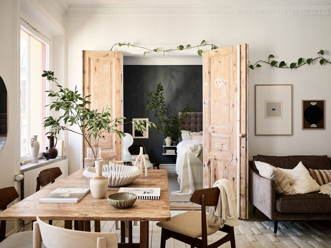 A Swedish Apartment with an Exposed Brick Wall 4 living-room-dining-table-double-wooden-doors-nordrom