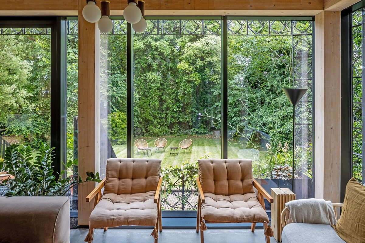 A Modern English Home with a Sculptural Facade 4 living-room-floor-to-ceiling-windows-garden-nordroom