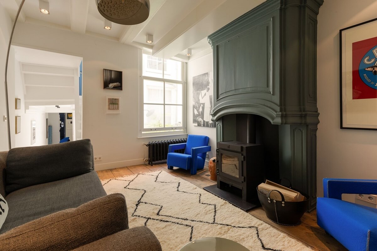 A Family Home in a Historic Canal House 10 living-room-green-fireplace-kobalt-blue-chairs-nordroom