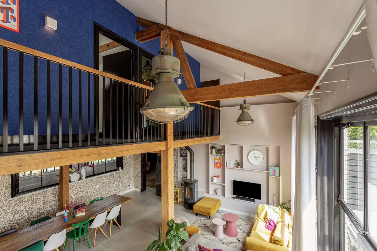 A Colorful School Conversion in The Netherlands 7 loft-space-exposed-beams-school-conversion-nordroom