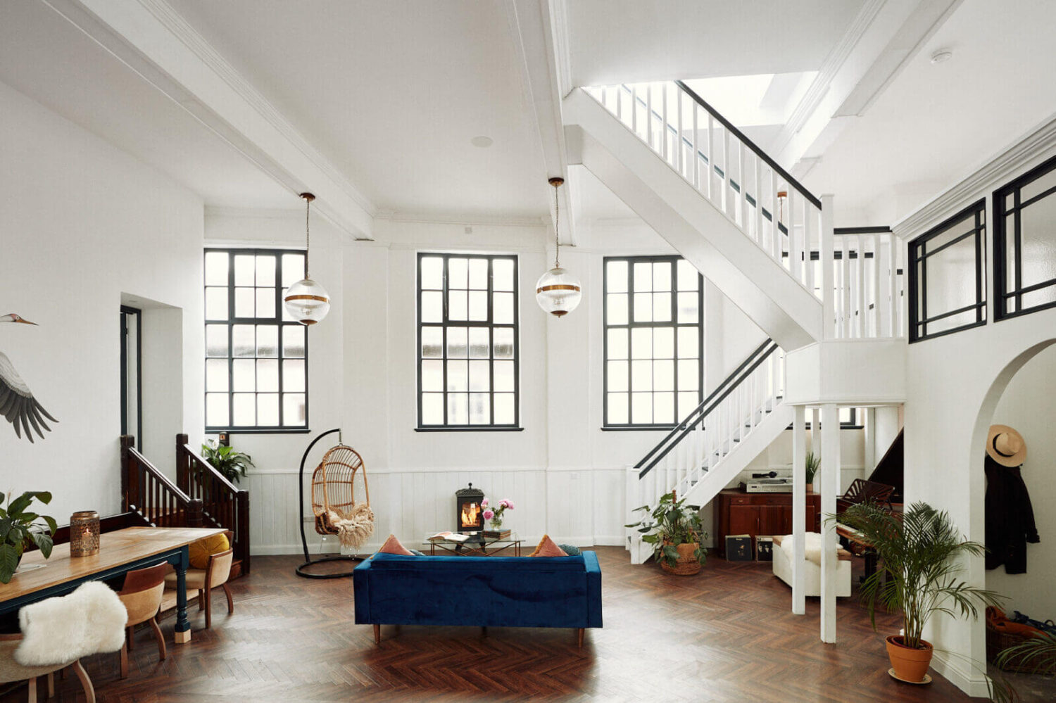 Loft Style Spaces in a Renovated Salvation Army Hall 2 loft-style-living-room-blue-couch-staircase-nordroom