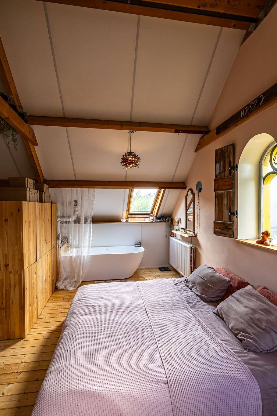A Colorful Church Conversion in The Netherlands 24 master-bedroom-exposed-wooden-beams-freestanding-bath-nordroom