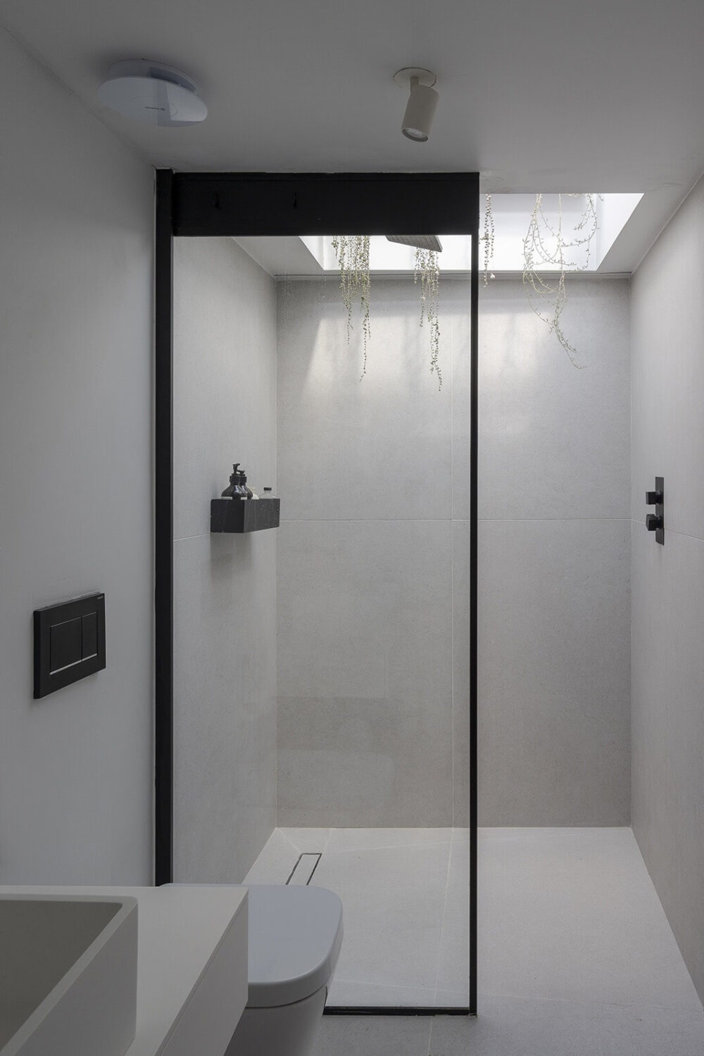 A Victorian House with Stylish Contemporary Interiors 16 minimalistic-bathroom-gray-tiles-walk-in-shower-skylight-nordroom