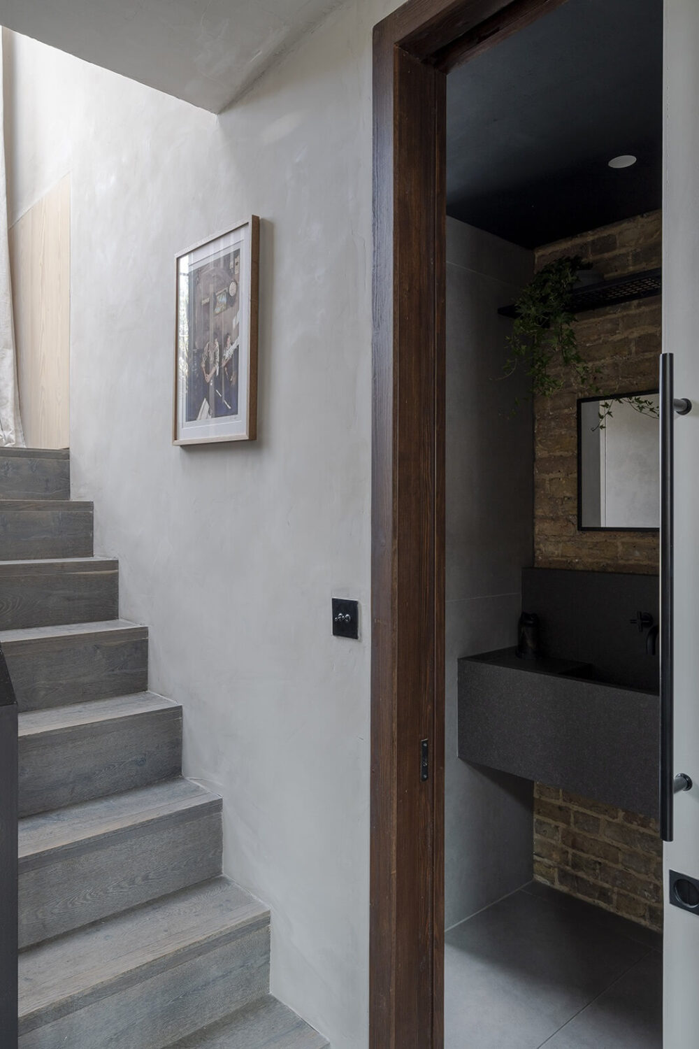 A Victorian House with Stylish Contemporary Interiors 11 modern-concrete-staircase-powder-room-nordroom