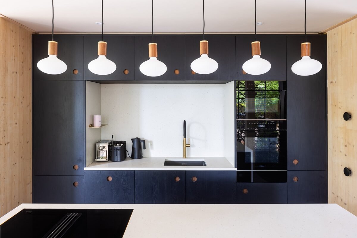 A Modern English Home with a Sculptural Facade 12 modern-kitchen-with-island-pendants-nordroom