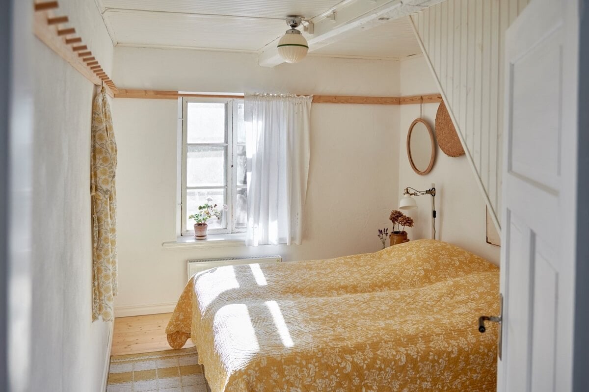 Natural Light in a Charming Swedish Country House 16 natural-light-bedroom-yellow-bedding-nordroom