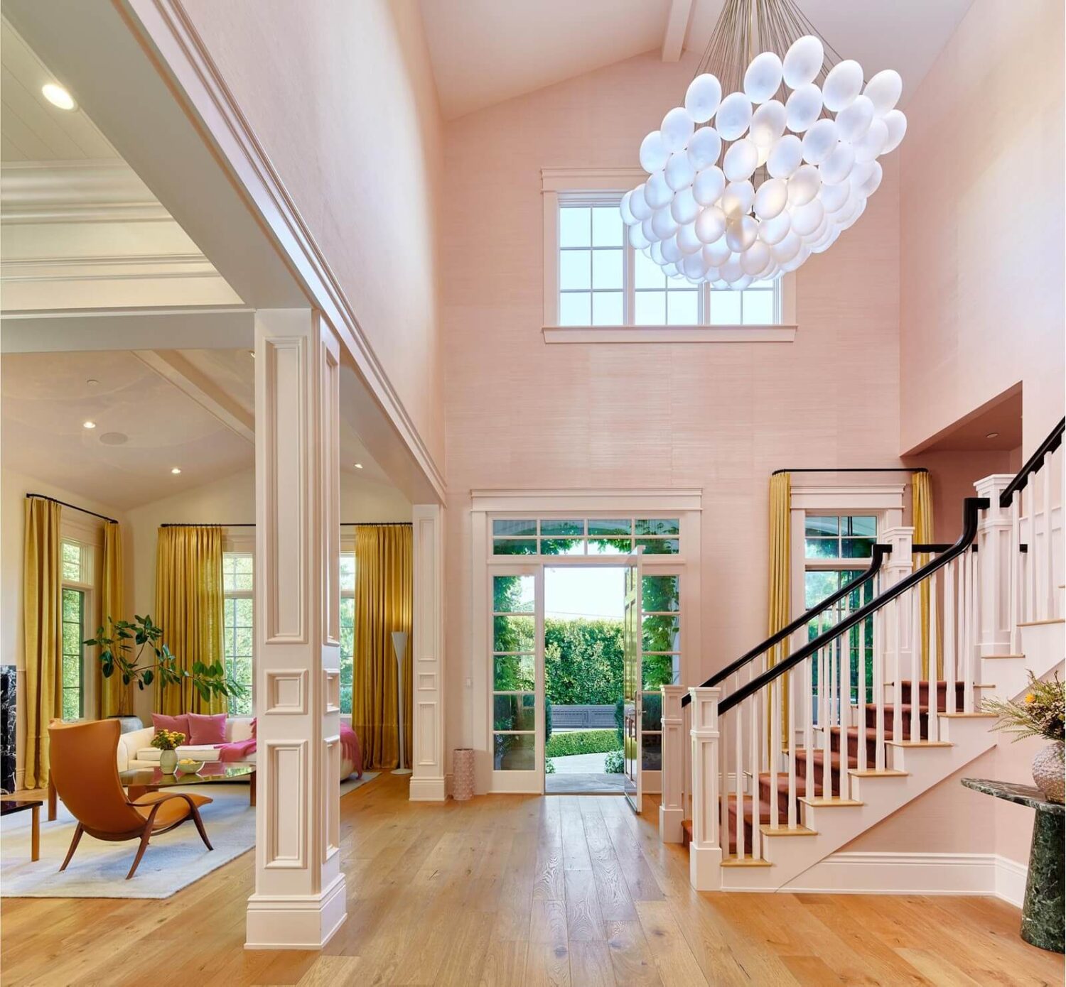 17 Shades of Pink in Fredrik Eklund's Beverly Hills Home 2 open-plan-foyer-living-room-high-ceilings-staircase-pink-wallpaper-nordroom