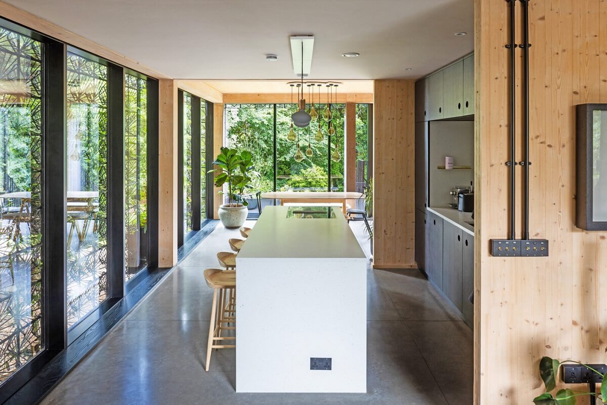 A Modern English Home with a Sculptural Facade 11 open-plan-interiors-kitchen-bar-nordroom