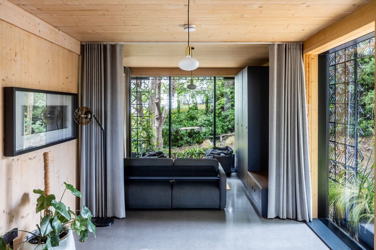 A Modern English Home with a Sculptural Facade 8 open-plan-living-room-curtains-glass-walls-nordroom