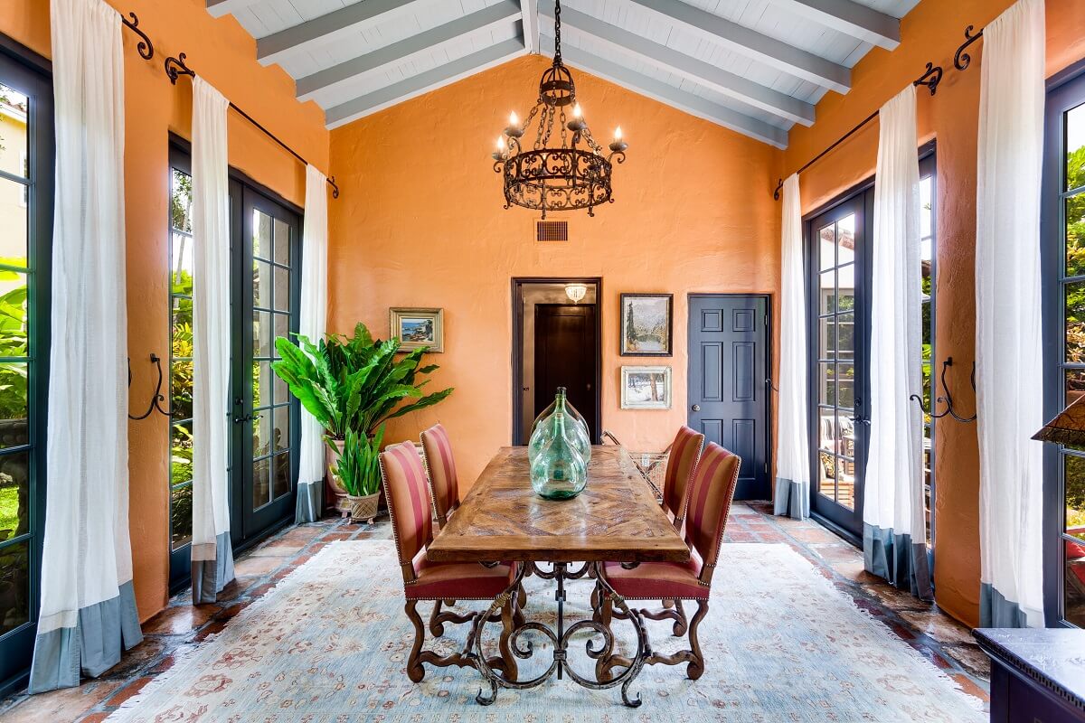 A Beautiful Spanish Style Home in Florida 16 orange-walls-large-rug-dining-room