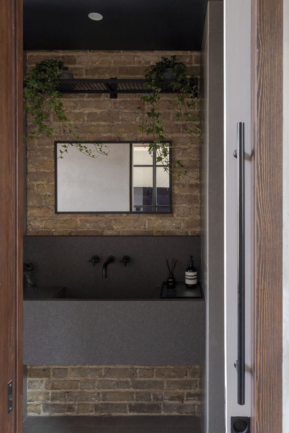 A Victorian House with Stylish Contemporary Interiors 10 powder-room-brick-wall-modern-gray-sink-nordroom