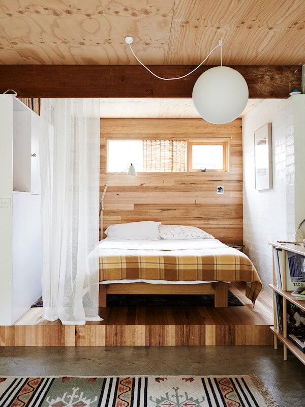 53 Studio Apartments with a Curtain Room Divider 50 raised-wooden-bedroom-area-studio-with-curtain-room-divider-nordroom