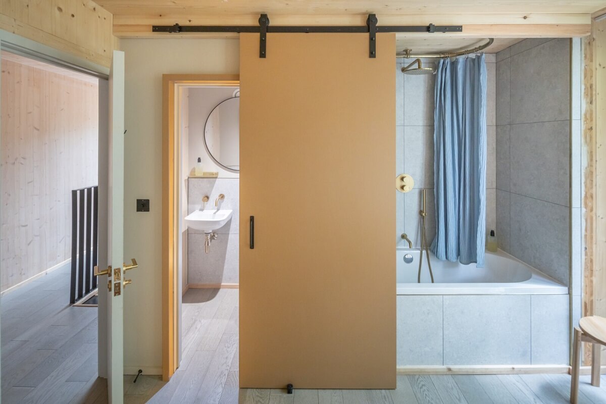 A Modern English Home with a Sculptural Facade 18 sliding-wooden-door-bathroom-bath-nordroom