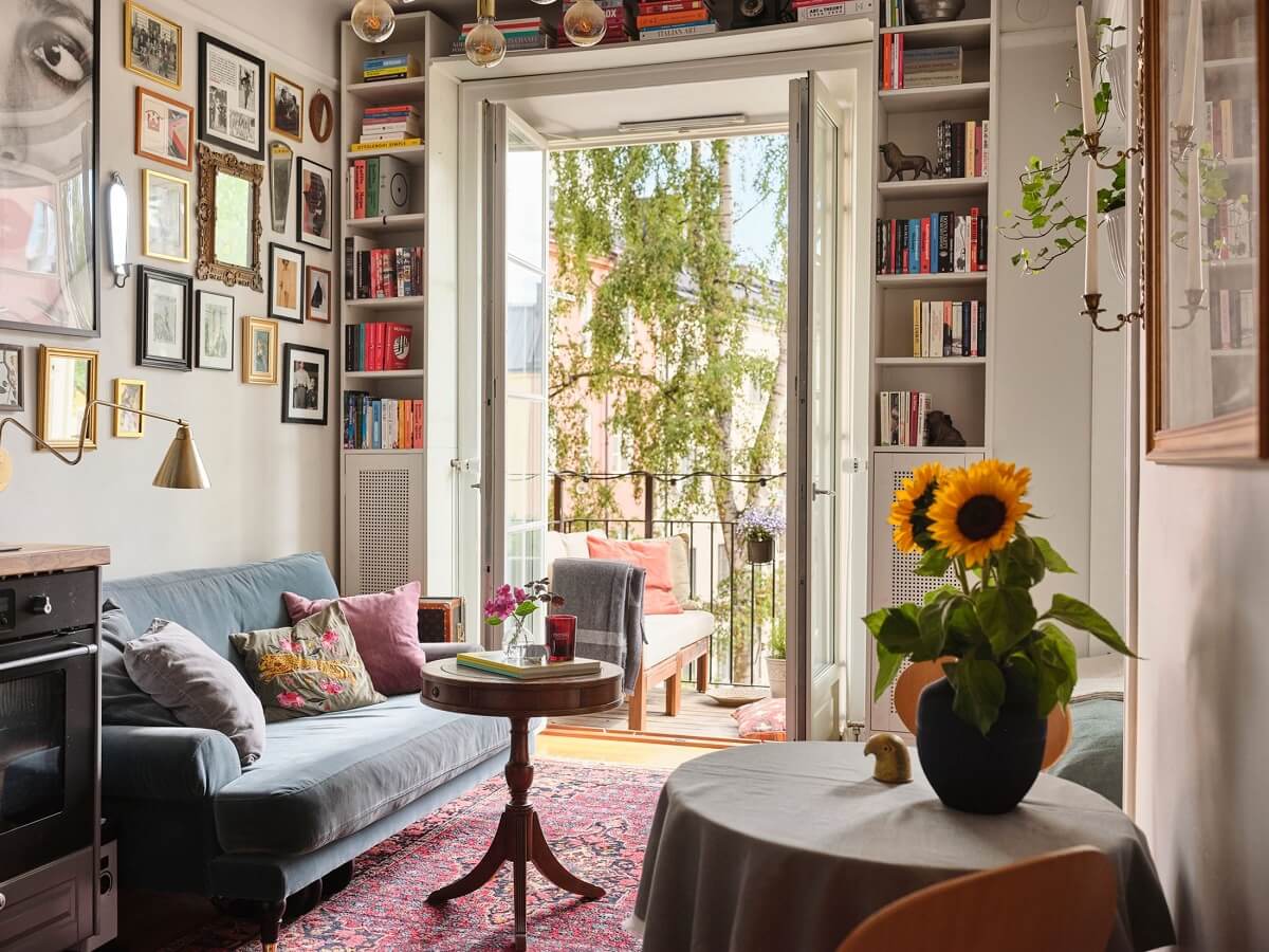 A Small Studio with a French Style Sitting Area 2 small-living-area-rug-bookcases-around-window-nordroom